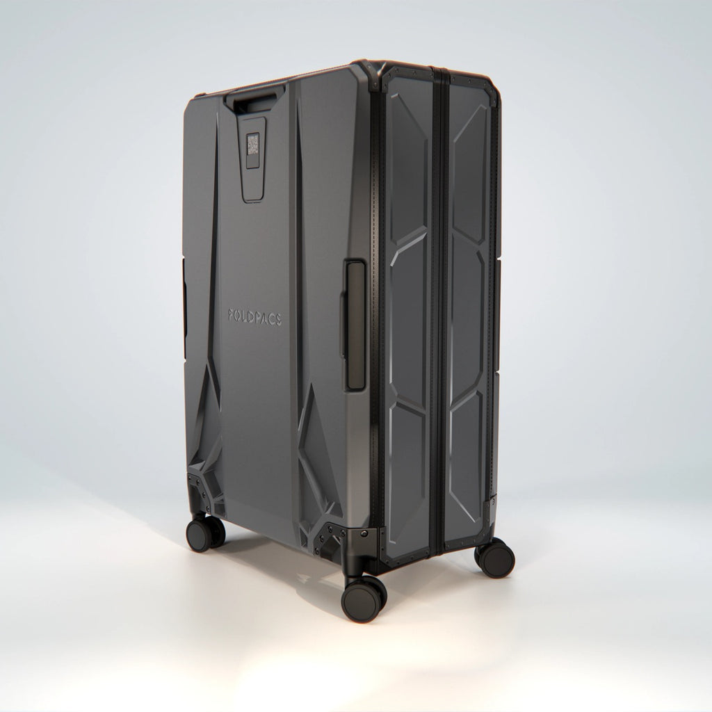 Anthracite FOLDPACS suitcase in three-quarter view on four spinner wheels