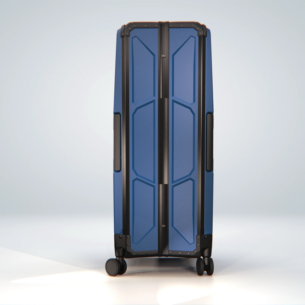 FOLDPACS suitcase in navy, upright side view showing the slim profile of the hard shell
