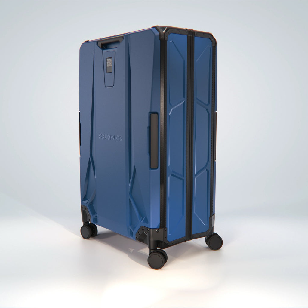 Navy FOLDPACS suitcase at a three-quarter angle on four spinner wheels