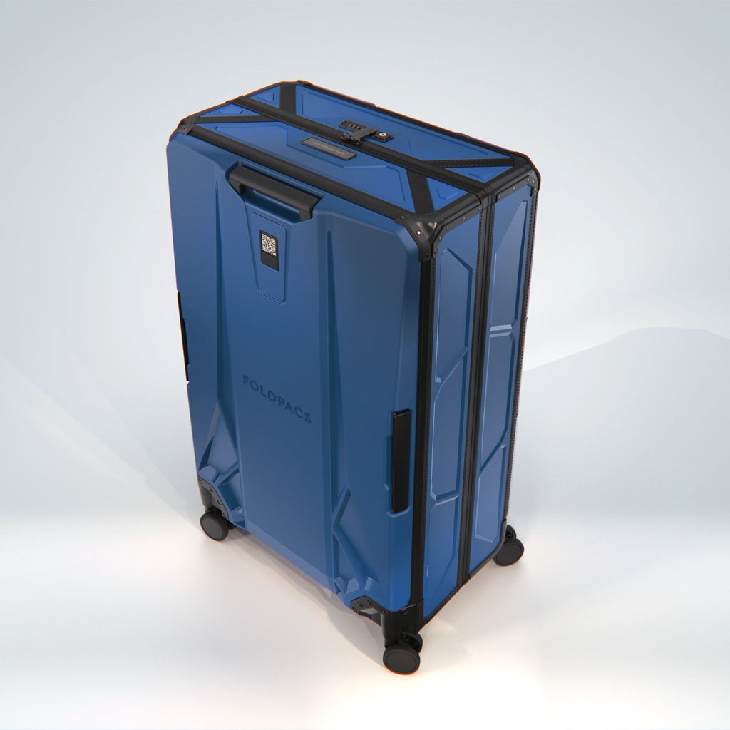 Navy FOLDPACS suitcase in three-quarter view with side carry handle