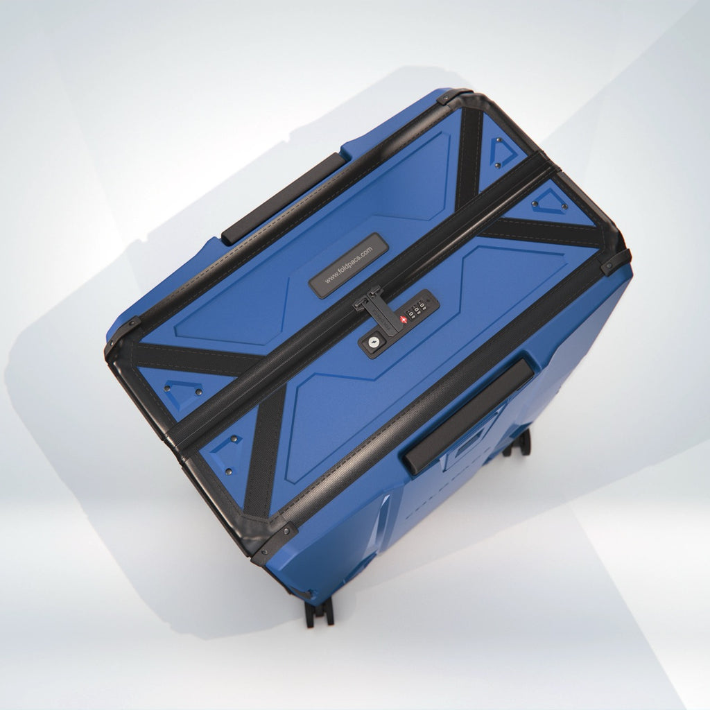 Navy FOLDPACS hard-shell suitcase seen from above at an angle, closed